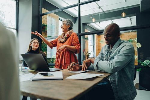 Cheerful businesspeole having a meeting a creative workplace