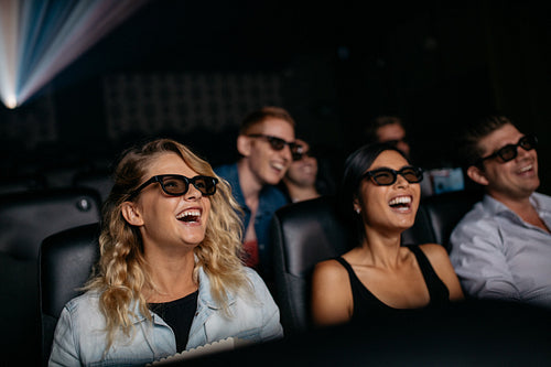 Friends watching 3d movie and laughing