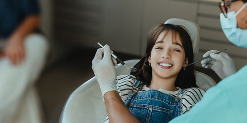 Dentist performs an exam with a child during a positive clinic checkup