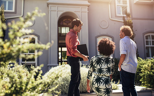 Real estate agent showing house to a couple