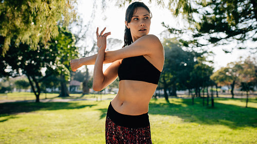Female runner stretching hands before working out