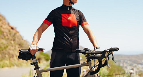 Cyclist standing with his bike - Outdoors