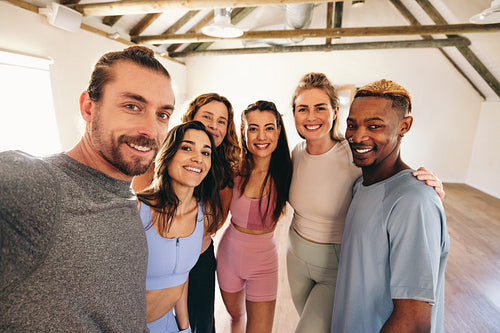 Group of happy people taking a selfie together in a yoga studio