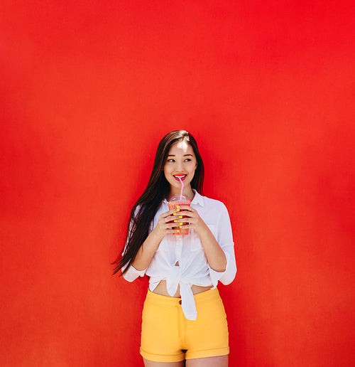 Smiling woman enjoying a smoothie