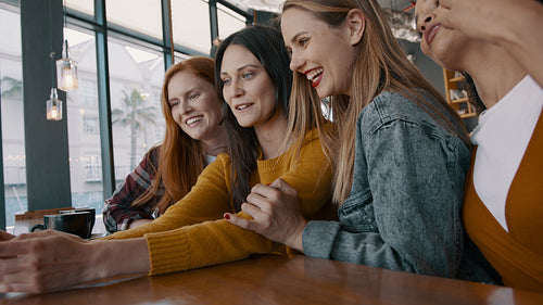 Female friends taking a selfie at the cafe