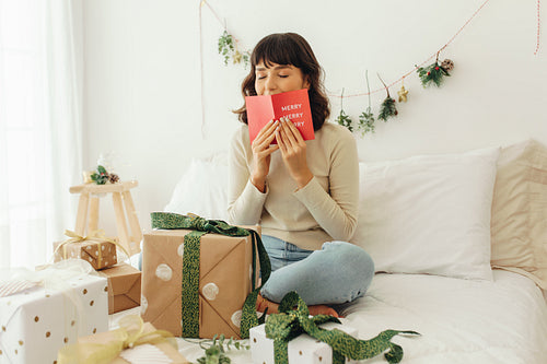 Woman kissing a christmas greeting card