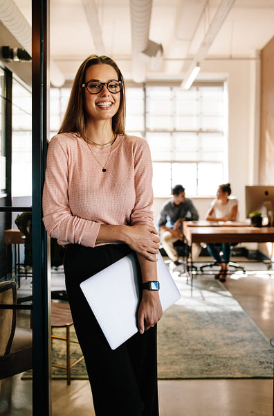 Happy female startup employees at office doorway