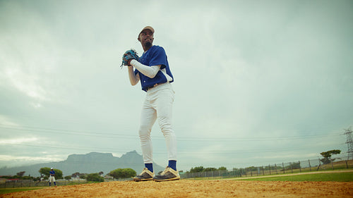 Baseball pitcher unleashes a powerful throw from the mound