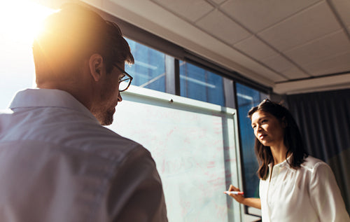 Business colleagues discussing ideas in office.