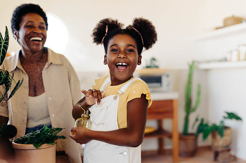 Nurturing mother and daughter enjoying indoor garden time together