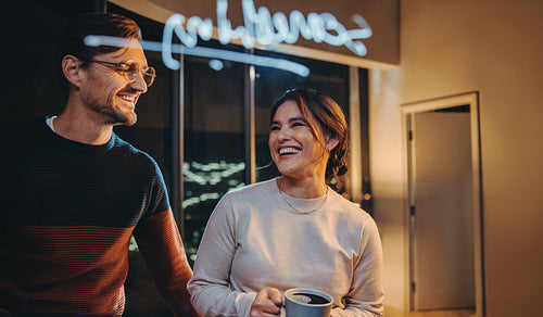 Office collaboration at night: Happy entrepreneurs having a business strategy meeting