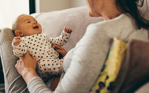 Close up of a mother sitting with her baby at home
