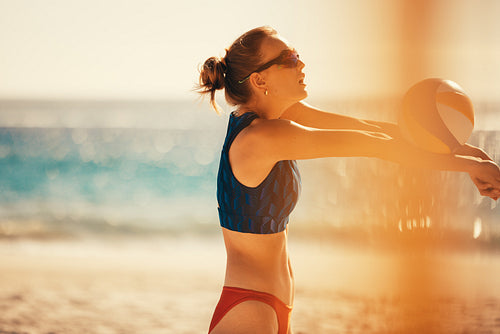 Pro beach volleyball player competes in championship match on sunny coastal court
