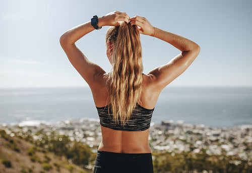 Female trail runner taking a break after run