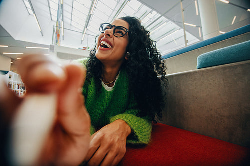 The happy woman with glasses brings a cheerful expression to this indoor portrait