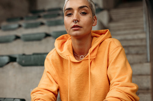 Close up of a woman sitting inside a stadium