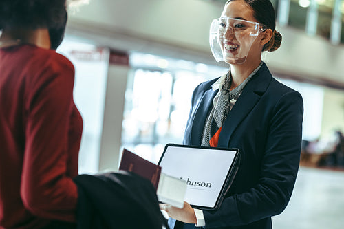 Private drive with face shield receiving businesswoman at airpor