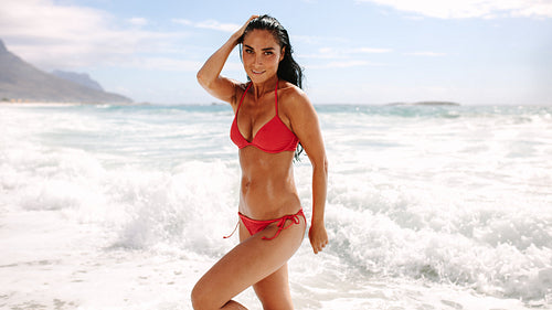 Beautiful woman posing in swimsuit on beach