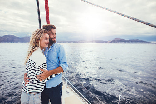 Young couple enjoying the view from a sailboat