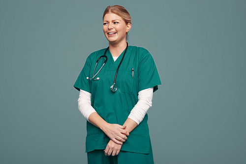 Young medical doctor smiling cheerfully in a studio