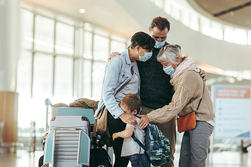 Senior woman receiving family at airport