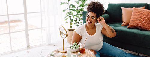 Woman having fun doing skincare treatment at home