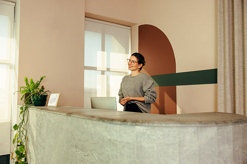 Friendly receptionist welcoming a client in an office