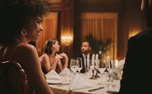 African woman at dinner party with friends