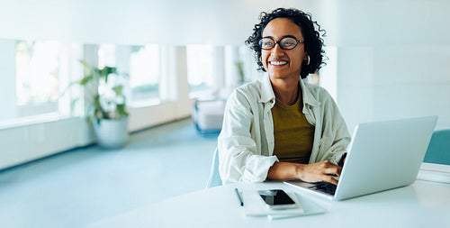 Female professional types on laptop in office today