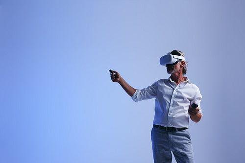 Mature businessman doing a presentation in the metaverse