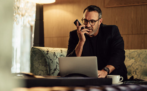 Businessman working in hotel lobby
