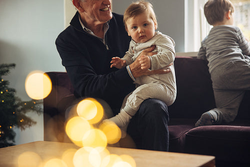 Kids with grandparents at home during Christmas