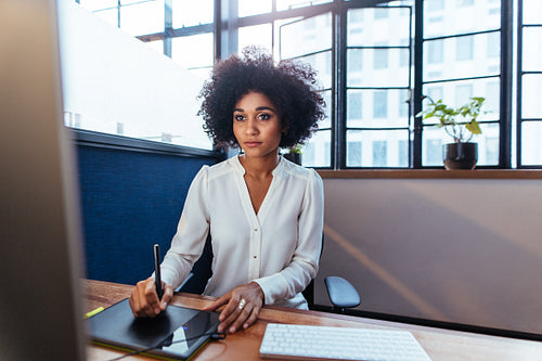 Female graphic designer working at her desk