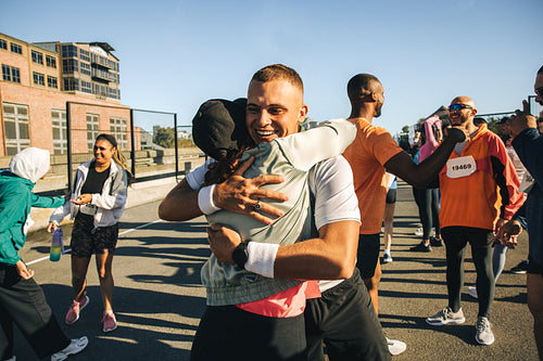 Runners embracing after completing a successful race event