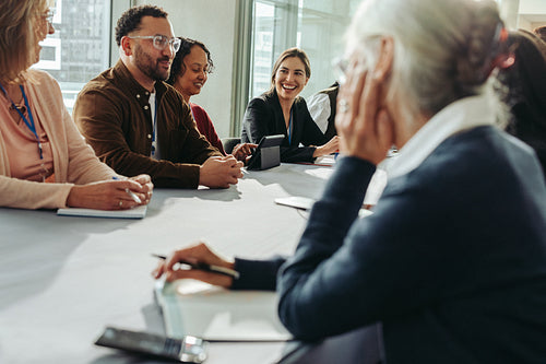Diverse business meeting with smiling participants in modern office environment