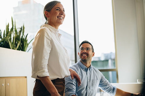 Colleagues smiling while working together