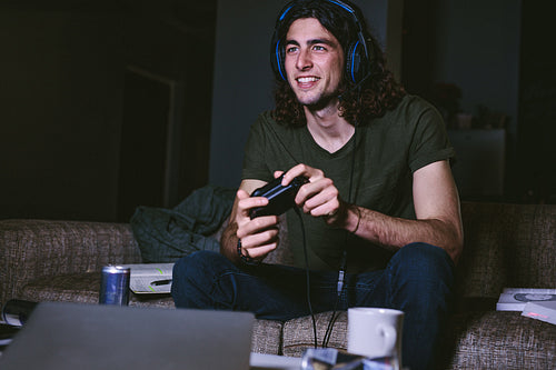 Man playing video game at home