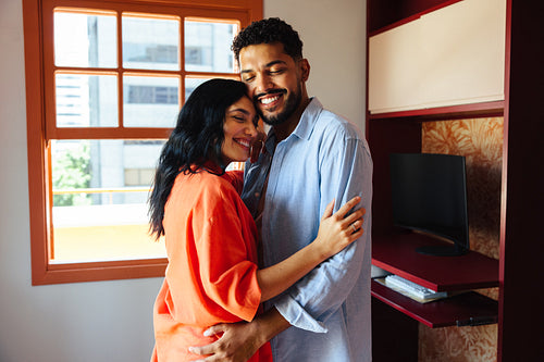 Happy couple embracing in a cozy home environment