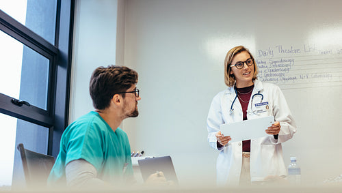 Female doctor leading meeting in hospital
