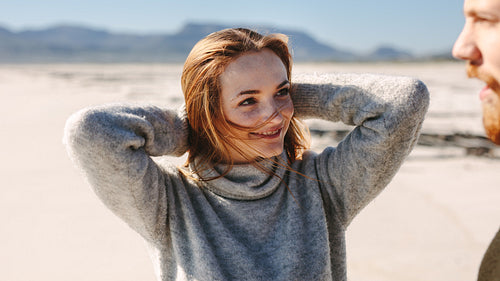 Woman on the beach looking at her boyfriend