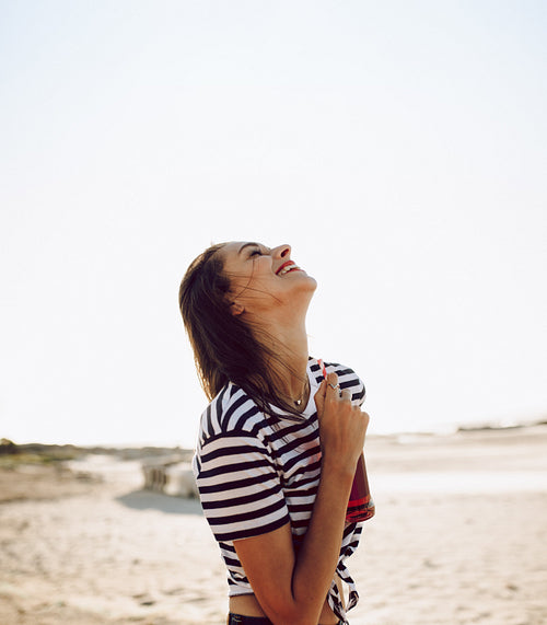 Cheerful woman with a soft drink outdoors