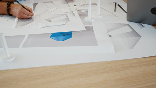 3D drawings for a wind energy project: Group of engineers designing a wind turbine as a team