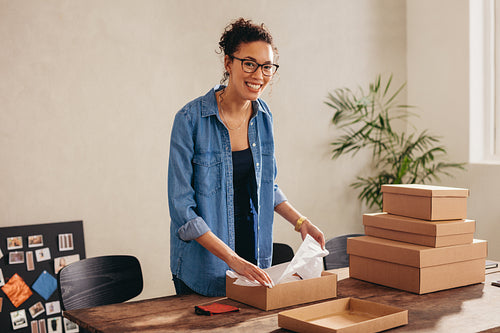 Woman seller preparing product for delivery