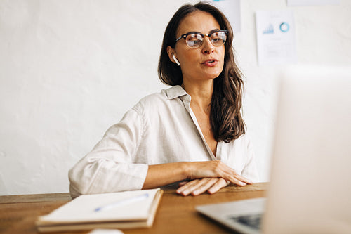 Professional business woman having a discussion with her colleagues on a video call