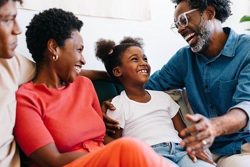 Family laughing and enjoying an afternoon together on the couch
