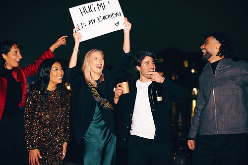 Group of friends celebrates a birthday outdoors at night