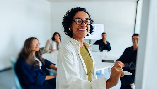 Team meeting with smiling leader presenting plan