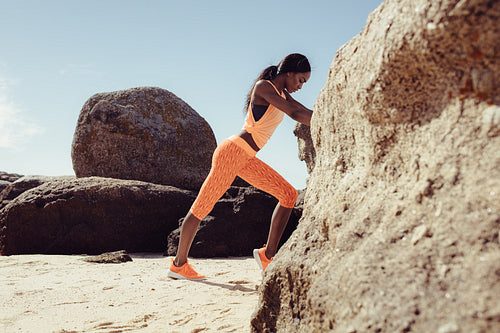 African woman resting at beach after her workout