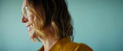 Smiling business professional woman in glasses against a plain background