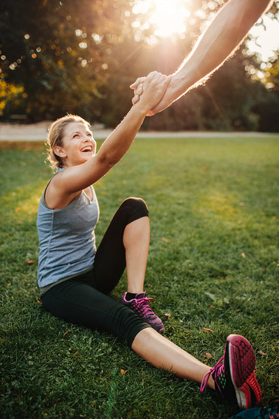 Man helping woman to stand up